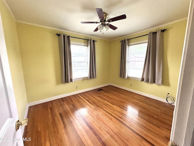 706 E Country Club Dr, Tarboro, NC 27886 - spare room with baseboards, ornamental molding, ceiling fan, and wood finished floors