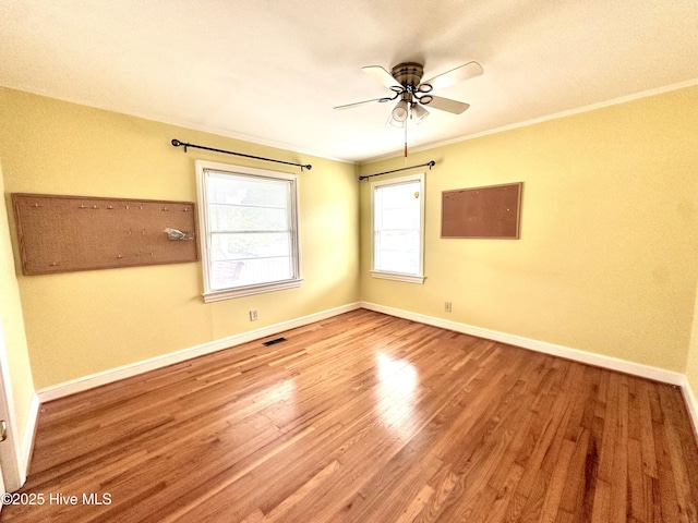 706 E Country Club Dr, Tarboro, NC 27886 - unfurnished room with a ceiling fan, baseboards, ornamental molding, visible vents, and wood finished floors