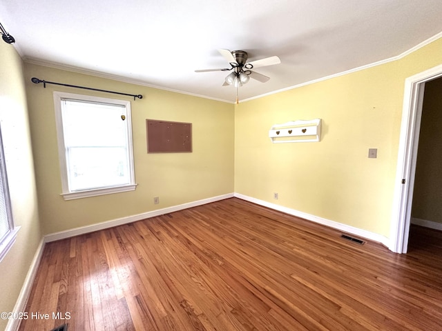 706 E Country Club Dr, Tarboro, NC 27886 - empty room featuring baseboards, ceiling fan, visible vents, crown molding, and wood finished floors