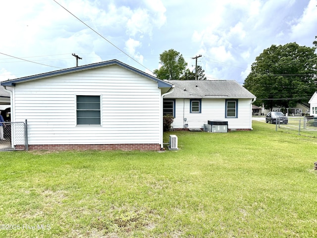 706 E Country Club Dr, Tarboro, NC 27886 - rear view of house with cooling unit, a shingled roof, fence, and a lawn