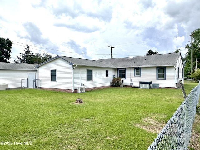 706 E Country Club Dr, Tarboro, NC 27886 - rear view of house featuring a yard, central AC unit, roof with shingles, and a fenced backyard