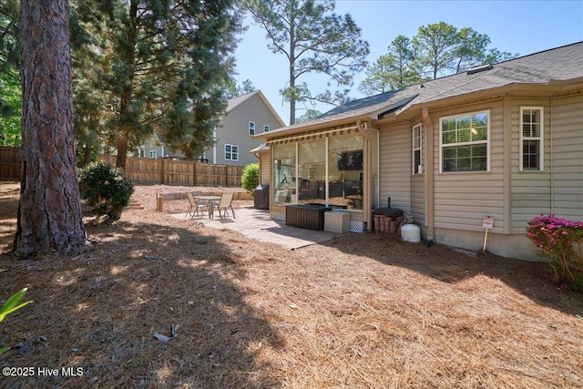 4 Brunswick Ln, Pinehurst, NC 28374 - rear view of house with fence, a patio, a sunroom, and roof with shingles