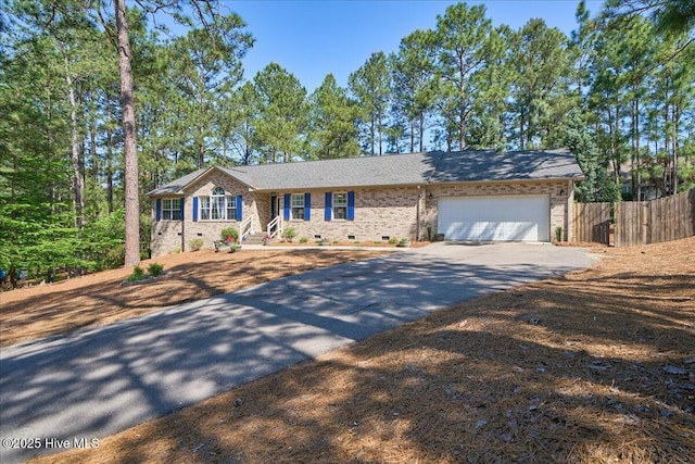 4 Brunswick Ln, Pinehurst, NC 28374 - ranch-style home with asphalt driveway, fence, an attached garage, and brick siding