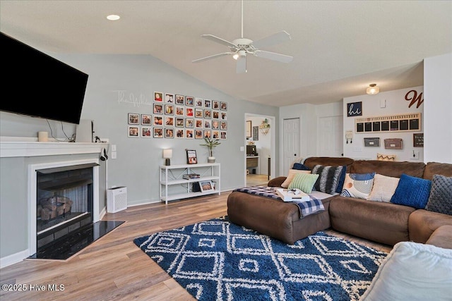 4 Brunswick Ln, Pinehurst, NC 28374 - living area featuring a ceiling fan, a fireplace with flush hearth, wood finished floors, vaulted ceiling, and baseboards