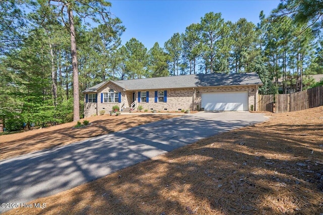 4 Brunswick Ln, Pinehurst, NC 28374 - ranch-style home with asphalt driveway, fence, an attached garage, and brick siding