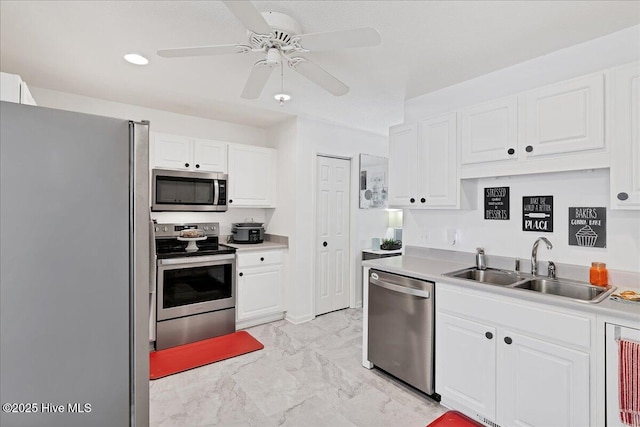 4 Brunswick Ln, Pinehurst, NC 28374 - kitchen with appliances with stainless steel finishes, a sink, white cabinetry, a ceiling fan, and light marble finish flooring
