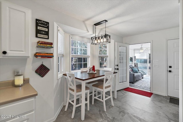 4 Brunswick Ln, Pinehurst, NC 28374 - dining area featuring a textured ceiling, a ceiling fan, and baseboards