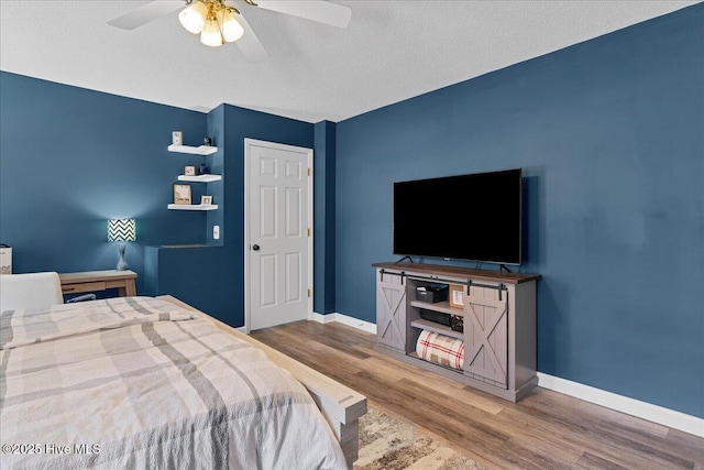 4 Brunswick Ln, Pinehurst, NC 28374 - bedroom with wood finished floors, baseboards, a ceiling fan, and a textured ceiling