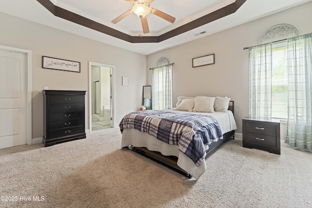 bedroom featuring ornamental molding, ceiling fan, visible vents, a raised ceiling, and carpet floors