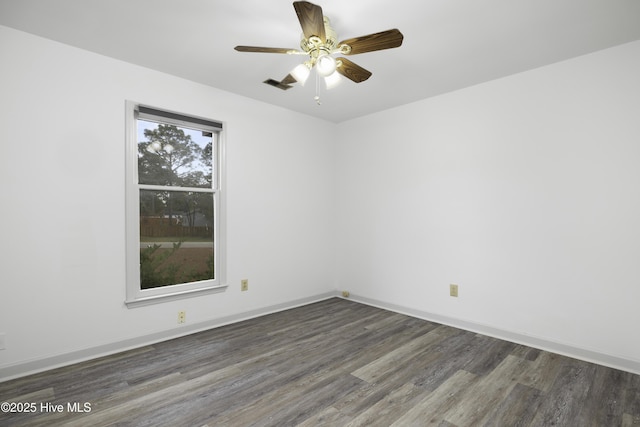 unfurnished room with baseboards, visible vents, wood finished floors, and a ceiling fan