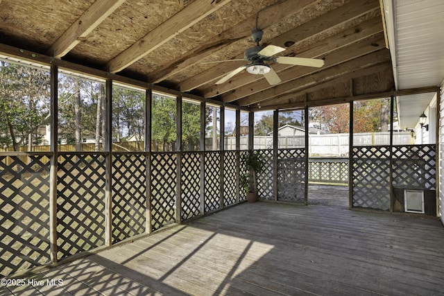 unfurnished sunroom with ceiling fan