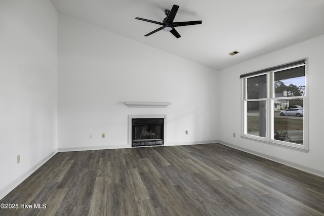 unfurnished living room with lofted ceiling, baseboards, visible vents, wood finished floors, and a fireplace