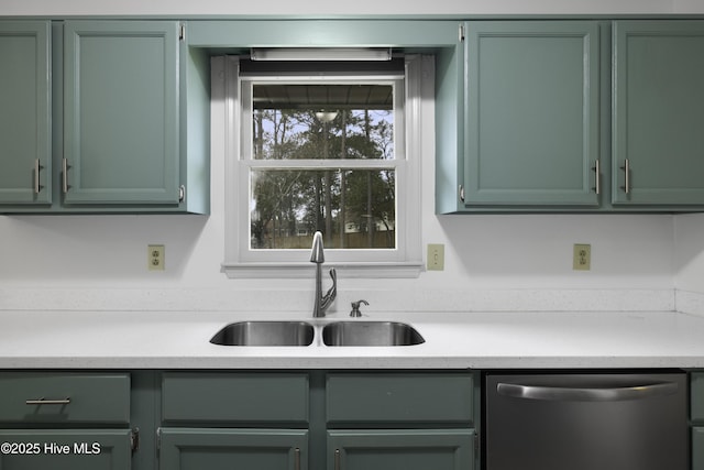 kitchen with green cabinets, light countertops, a sink, and dishwasher
