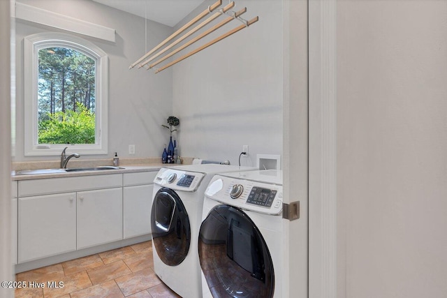 laundry room with independent washer and dryer, cabinet space, and stone finish floors