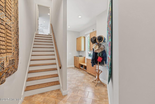 staircase featuring baseboards and recessed lighting