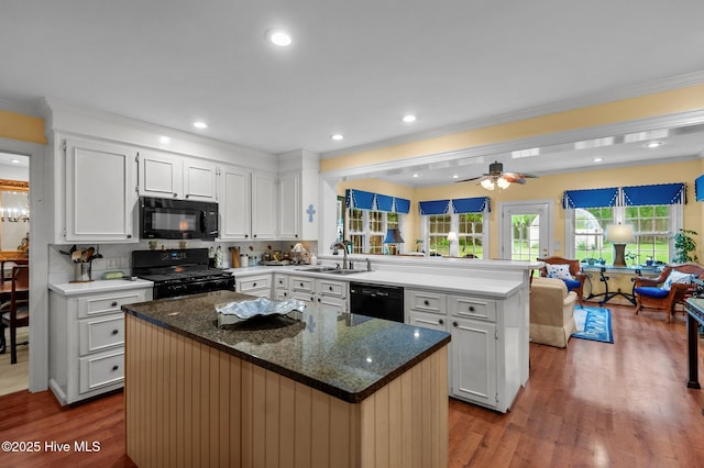 104 N Reed Dr, Washington, NC 27889 - kitchen with black appliances, a peninsula, dark wood-style floors, open floor plan, and crown molding