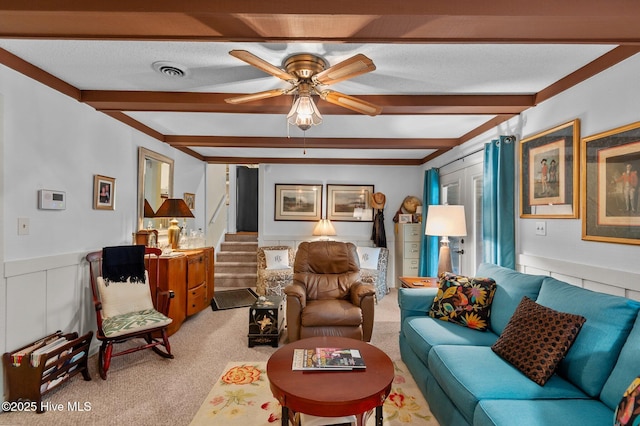 104 N Reed Dr, Washington, NC 27889 - carpeted living area with beamed ceiling, a ceiling fan, stairs, and wainscoting