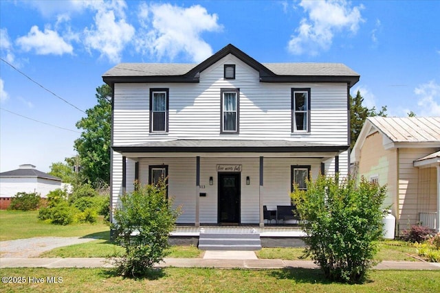 view of front of house with covered porch and a front lawn