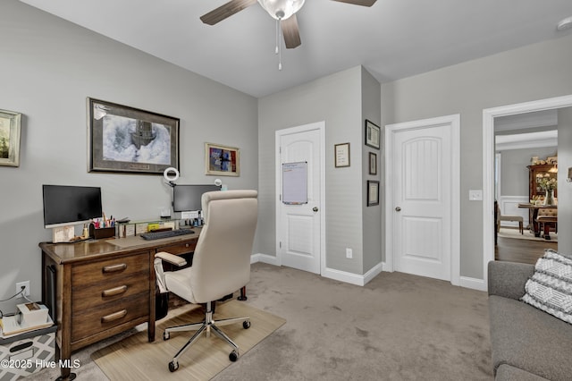 office area featuring light colored carpet, ceiling fan, and baseboards