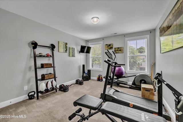 workout room with carpet flooring and baseboards