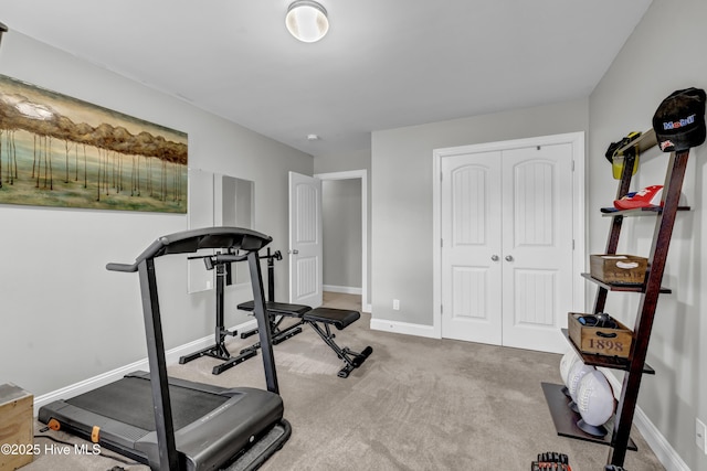 workout area featuring carpet flooring and baseboards