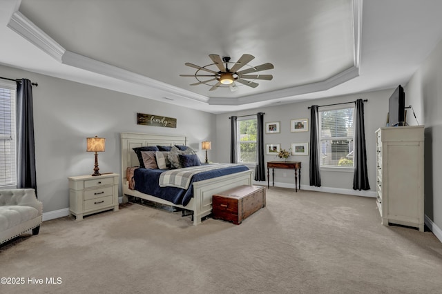 bedroom featuring light carpet, a raised ceiling, baseboards, and ornamental molding