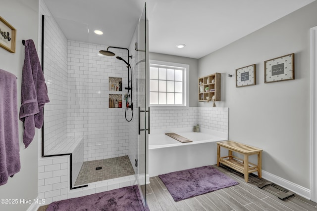 full bathroom with a garden tub, a shower stall, wood finish floors, and recessed lighting