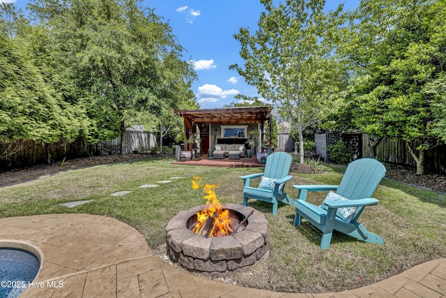 view of yard with an outdoor living space with a fire pit, a patio area, a pergola, and a fenced backyard