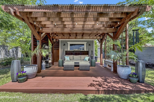 wooden terrace featuring a pergola, fence, and an outdoor living space