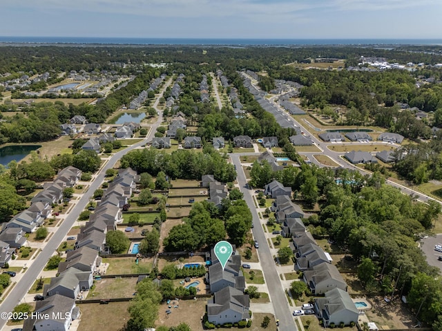 drone / aerial view featuring a water view and a residential view