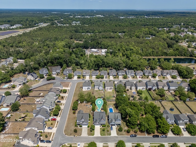 bird's eye view featuring a forest view and a residential view