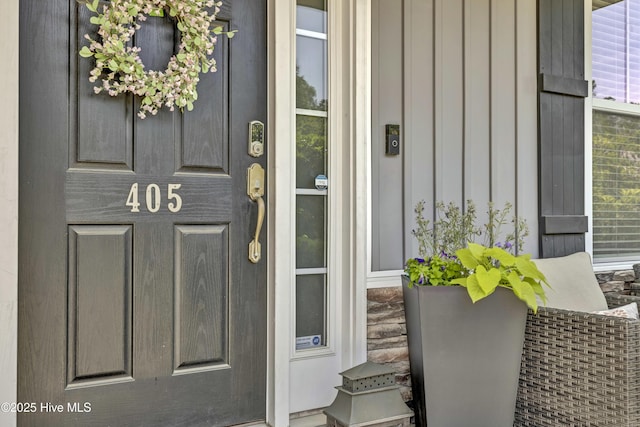 view of exterior entry featuring board and batten siding