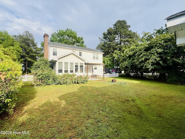 rear view of property featuring a chimney