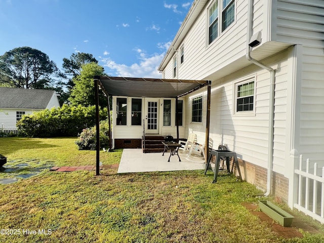 back of house with entry steps, a patio area, a yard, and crawl space