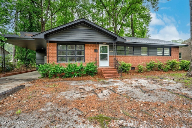 829 Burton St, Rocky Mount, NC 27803 - view of front of home featuring brick siding, a carport, concrete driveway, and entry steps