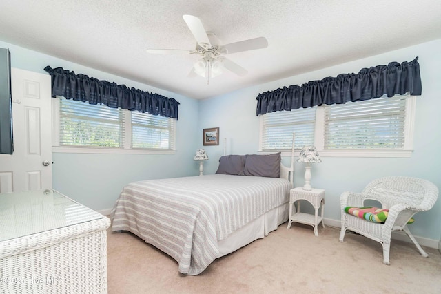 bedroom with baseboards, a ceiling fan, and light colored carpet