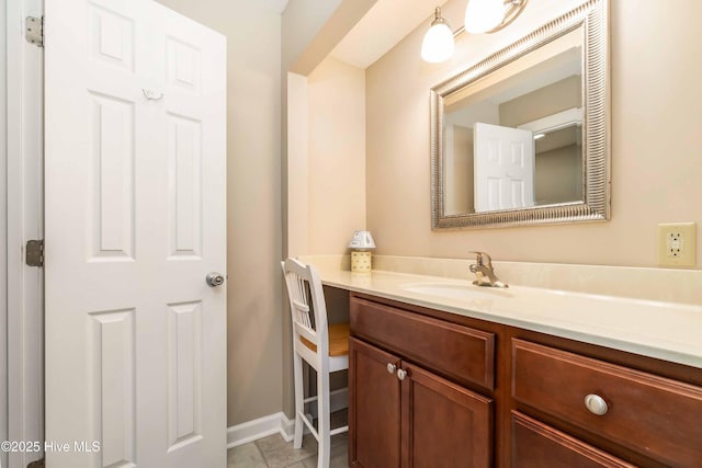 bathroom with vanity and baseboards