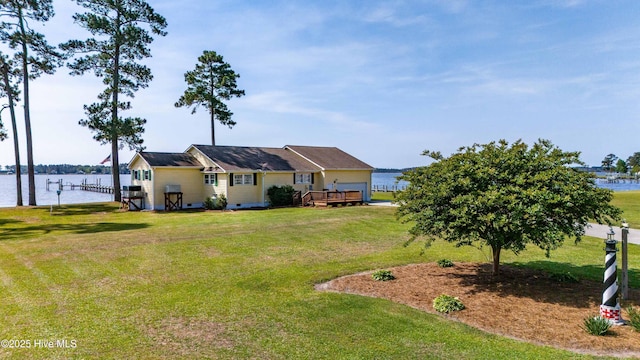 view of yard with a deck with water view