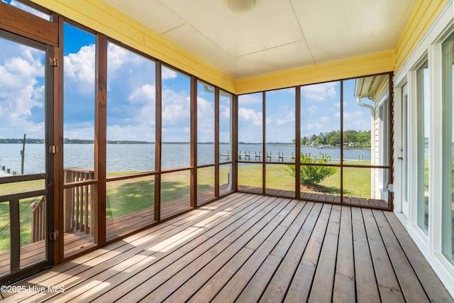unfurnished sunroom with wood finished floors and a deck with water view