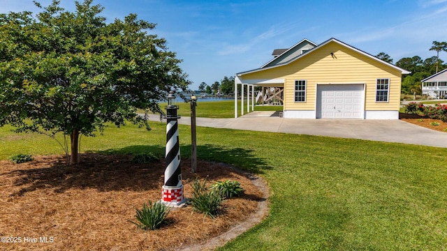 view of front of house featuring concrete driveway, a water view, and a front yard