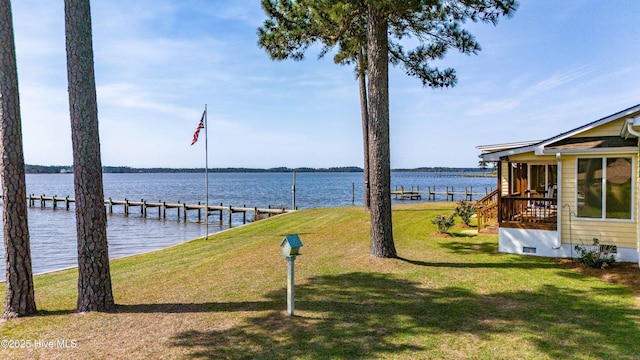 dock area featuring a yard and a water view