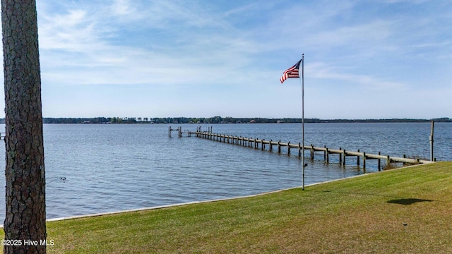 dock area with a water view and a lawn