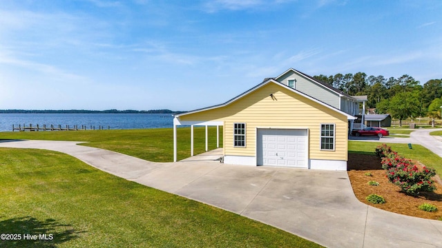 view of front of house with a water view, a garage, driveway, and a front yard