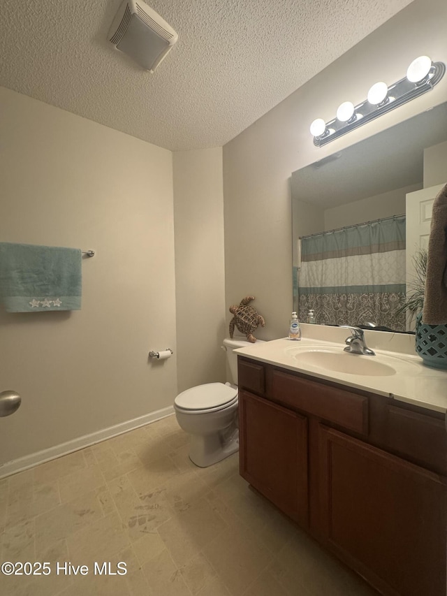 bathroom featuring a textured ceiling, visible vents, toilet, and vanity