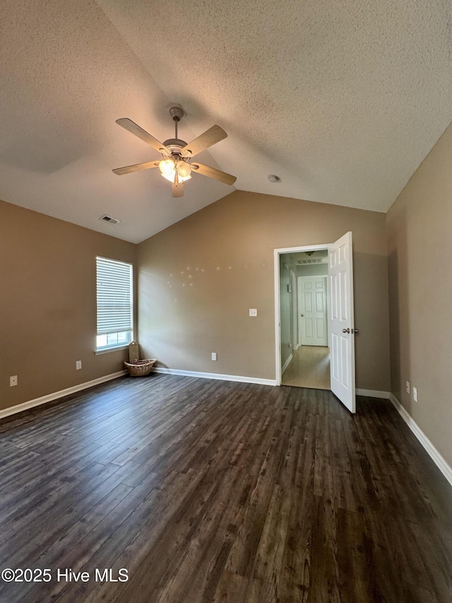 interior space featuring a textured ceiling, dark wood-type flooring, a ceiling fan, and visible vents