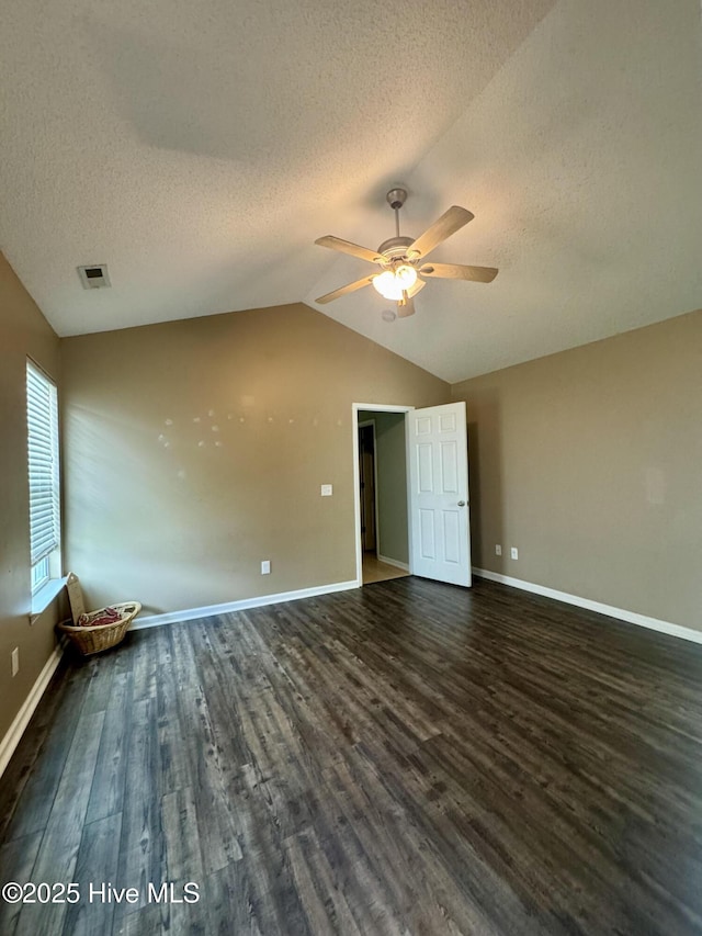 interior space with lofted ceiling, a textured ceiling, visible vents, and wood finished floors