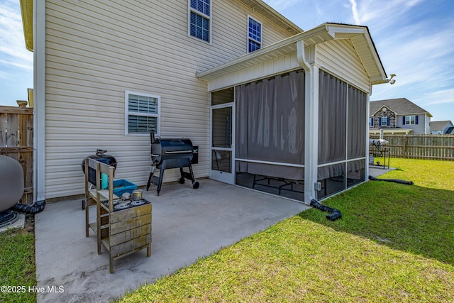 view of patio featuring a sunroom, fence, and grilling area