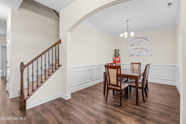 dining room featuring a notable chandelier, arched walkways, dark wood-style floors, and visible vents