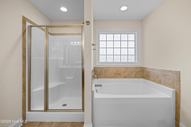 full bathroom featuring a shower stall, tile patterned floors, and a garden tub