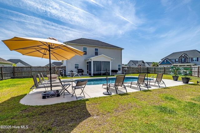 view of swimming pool featuring a patio, a fenced backyard, a fenced in pool, a lawn, and a sunroom